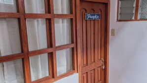 A wooden door with a sign that reads "Pumpkin."