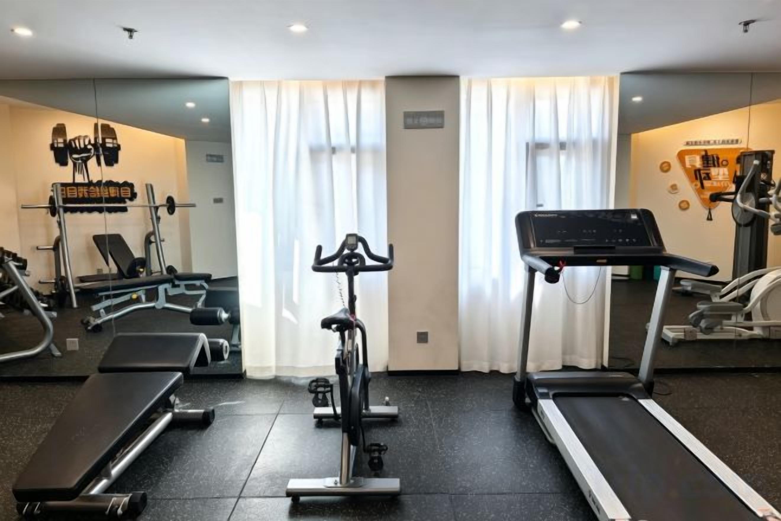 A gym with treadmills, stationary bikes, and weight machines.