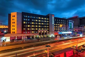 A multi-story hotel with a modern facade, illuminated windows, and a prominent signage on the building. - Yatai Longda Hotel (Changchun)
