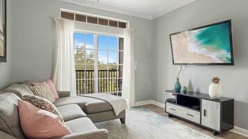 Casa de ciudad, varias camas, balcón, vista al jardín (Good Times At Tuscana) | Área de sala de estar | Televisión de 42 pulgadas con canales digitales