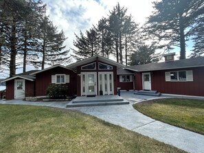 A two-story house with a front porch, a garage, and a driveway.
