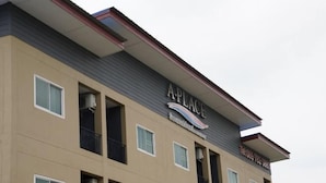 A multi-story building with a sign reading "A-PLACE" and a phone number. - A-Place Suvarnabhumi (Bang Phli)