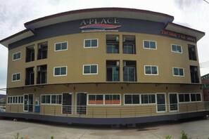 A multi-story building with a curved roof, labeled 'A PLACE' and 'Hotel & Restaurant'.