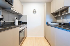 Comfort Apartment | Private kitchen | Full-sized fridge, toaster, griddle, paper towels