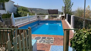 A rectangular swimming pool with a tiled deck, surrounded by a white fence with balusters. - Casa Rural VillaGloria Montefrío by Ruralidays (Granada)