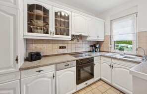 Fridge, stovetop, dishwasher, coffee/tea maker