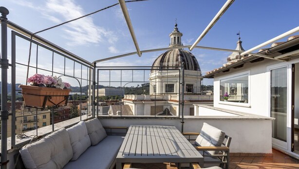 A rooftop terrace with a seating area, a table, and a potted plant. - LaDolcevita - Ponte Milvio Stunning View Penthouse (Roma)