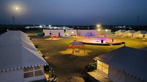 A series of tents with a central stage area, likely for events or gatherings. - Rajasthan Desert Camp  (Jaisalmer)
