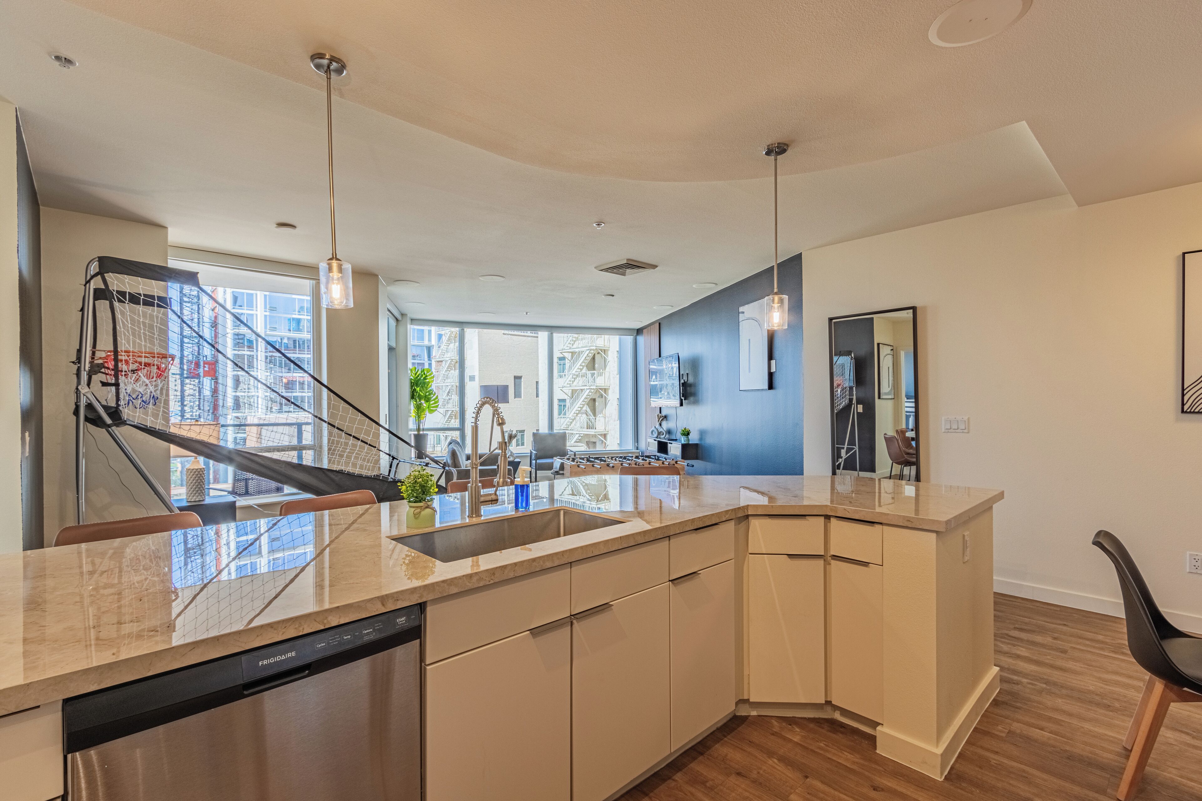 A modern kitchen with a dishwasher, a sink, and a built-in stove.