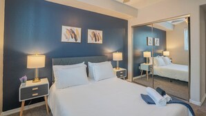 A hotel room with a large bed, two bedside tables with lamps, a ceiling fan, and artwork on the wall. - ROVE LIVING/KL - The Fredrick Tempe (Tempe)