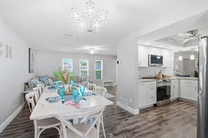A modern kitchen with white cabinets, a stainless steel refrigerator, and a built-in oven. - Heated Pool + Hot Tub | 3 Kings | Near the Beach (Largo)
