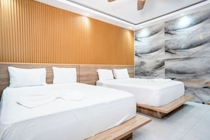 A hotel room with two beds, wooden headboards, and a marble wall. - Casual On the Beach Bayahibe by Casual Hoteles (Bayahíbe)