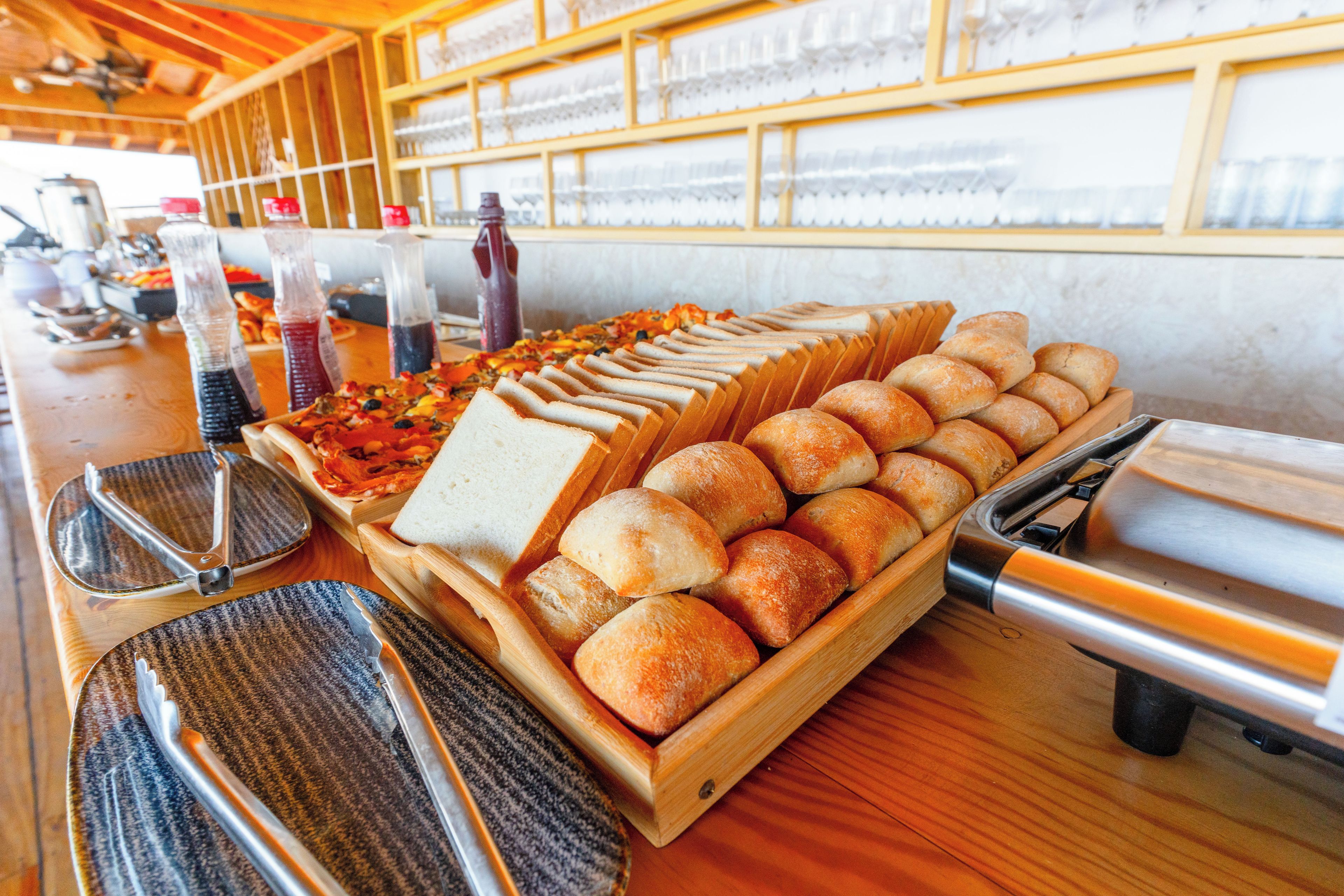A buffet with various food items and utensils.