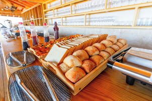 A buffet with various food items and utensils.