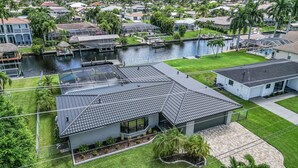 A residential area with houses, a canal, and a swimming pool.