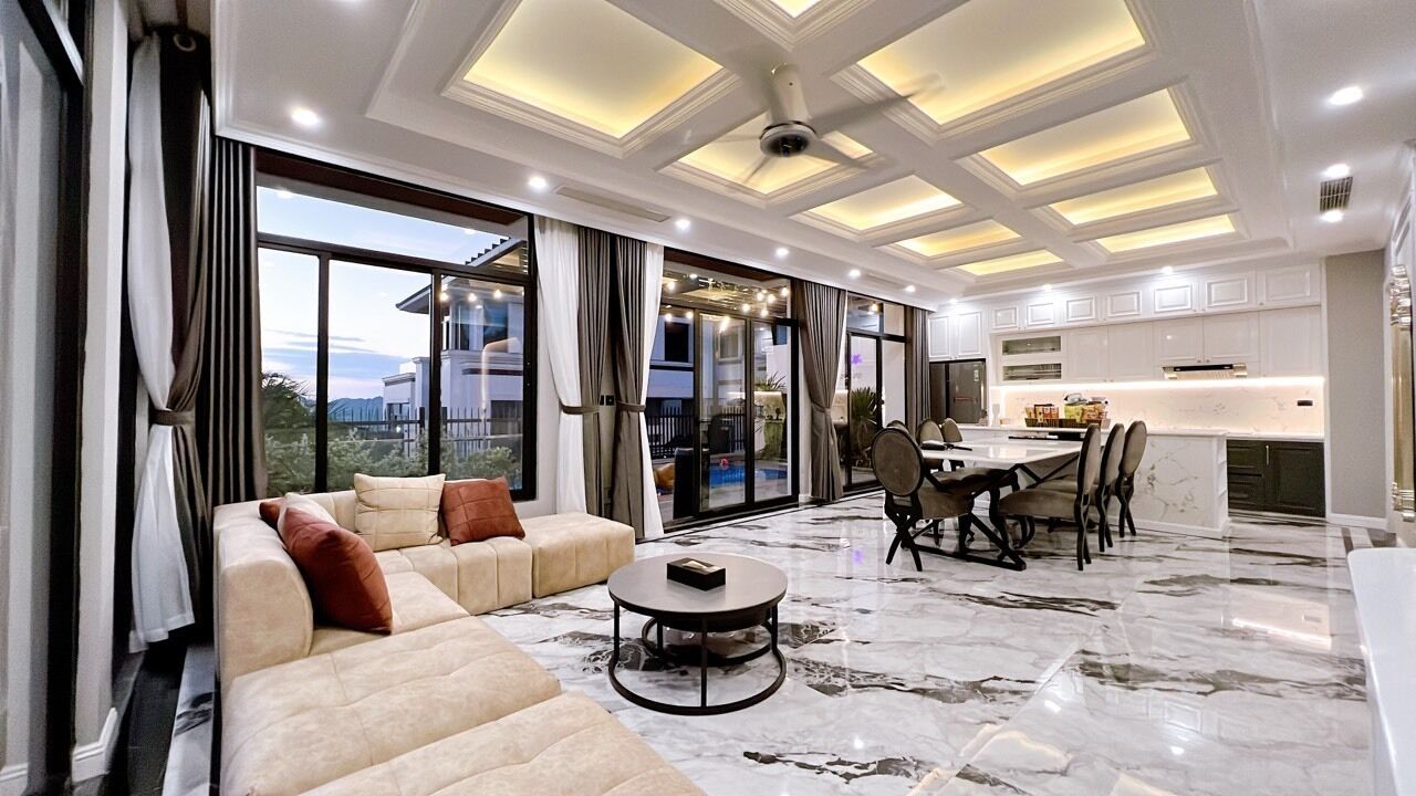 A spacious living room with a sofa, coffee table, and dining area.