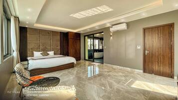 Un dormitorio moderno con una cama grande, un tocador y vistas al exterior.