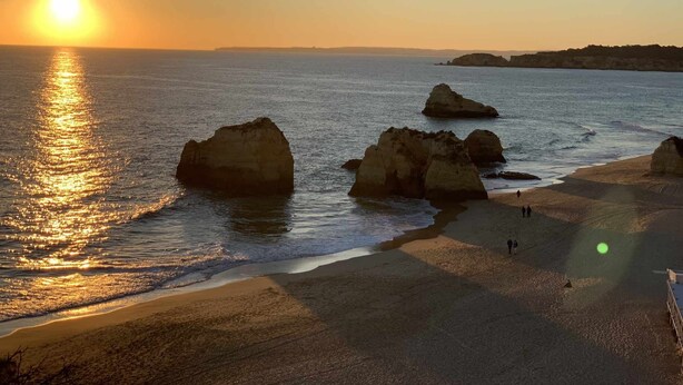 A beach with large rock formations and a sunset in the background. - Spa Suite 3: Pool, Jacuzzi & Sauna (Poço Partido)