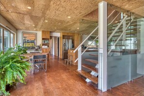 A modern kitchen with wooden cabinets, stainless steel appliances, and a large poster on the wall. - Spacious 5-br 4-bath Pool in East Hamptons (East Hampton)