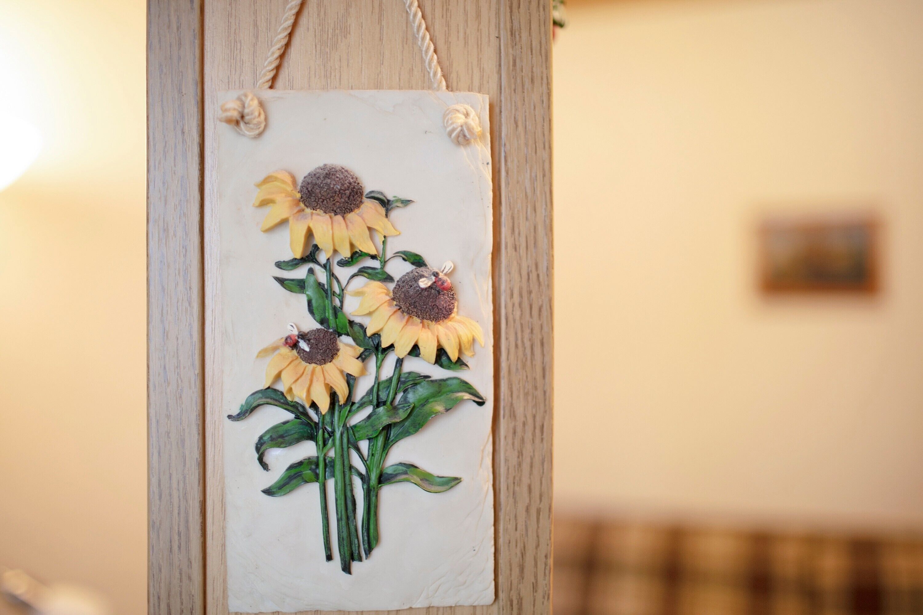A wall-mounted decoration with a sunflower design.