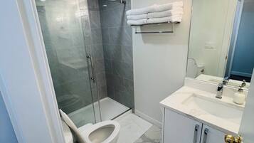 Shower, hair dryer, towels, soap