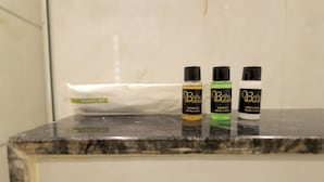 A bathroom counter with a dental kit and three bottles of Bath & Body products. - Hotel Shrinath Palace (Mathura)