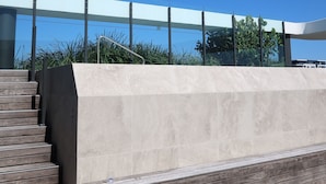 A modern outdoor staircase leading to a terrace with a clear view of the sky and surrounding greenery. - Luxury Palm Beach 1 BDR in The Village (Palm Beach)