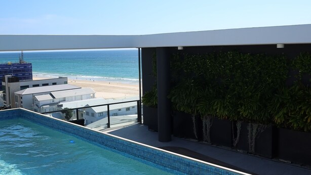 A swimming pool with a view of the beach and ocean. - Luxury Palm Beach 1 BDR in The Village (Palm Beach)