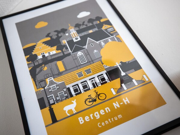 A framed cityscape illustration with a bicycle and a deer, labeled 'Bergen N-H Centrum'.