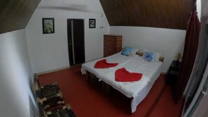 A bedroom with a bed, a wardrobe, and a door. - Pobitora Village Eco Camp (Mayang)