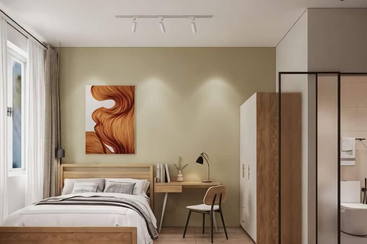 A bedroom with a bed, desk, chair, and artwork on the wall.