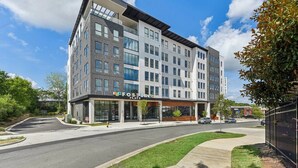 A multi-story building with a flat facade, large windows, and a storefront labeled "FOSTER FLATS". - Reluxme|European Flat Near Uptown King Bed + Views (Charlotte)