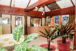 A reception area with a wooden interior, a reception desk, and various informational posters. - Casa Felicisima Inn (Puerto Princesa)