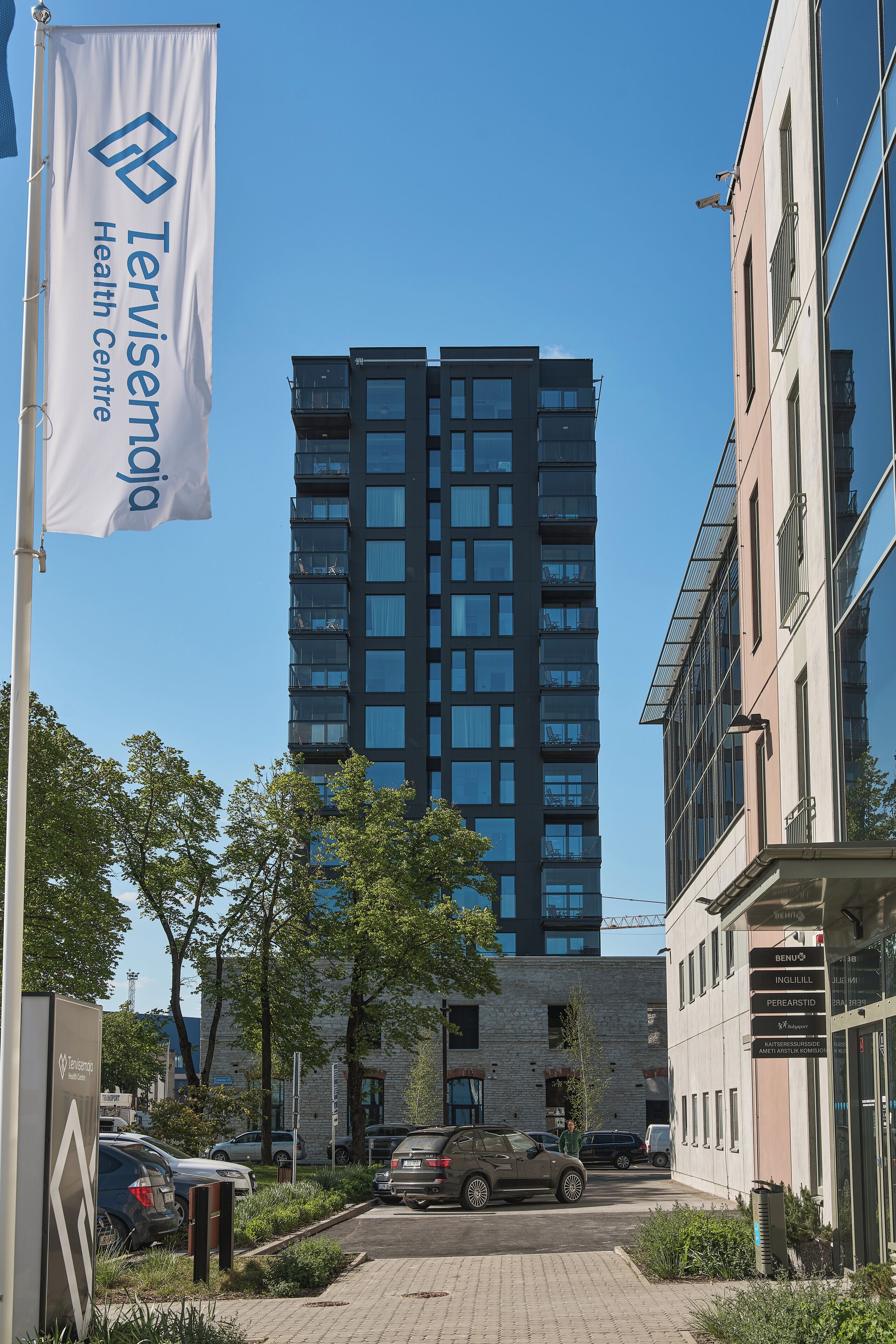 A modern building with a flag reading "Tervisensia Health Centre."