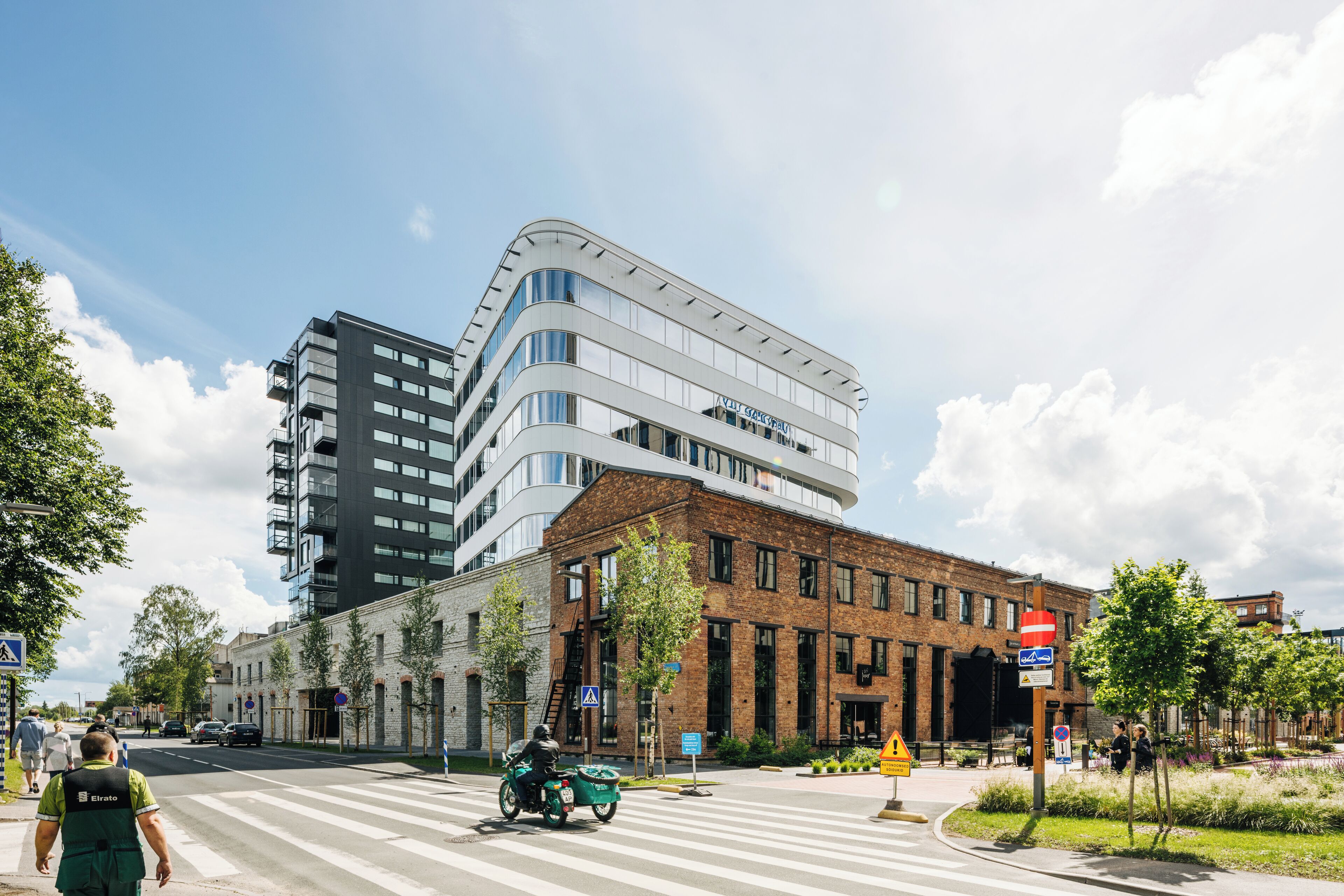 A modern building with a curved facade and multiple windows.