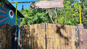 A bamboo gate with a sign above it.