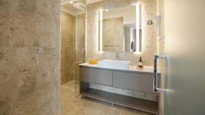 A modern bathroom with a glass shower enclosure, a white sink, and a large mirror. - Simma Luxury Apartments & Rooms (Belgrade)