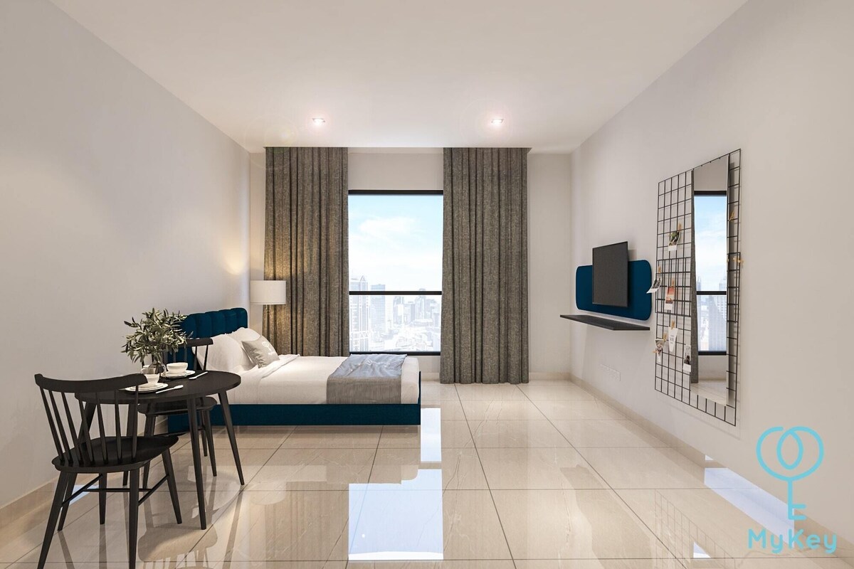 A modern hotel room with a bed, a desk, a chair, a TV, and a city view.
