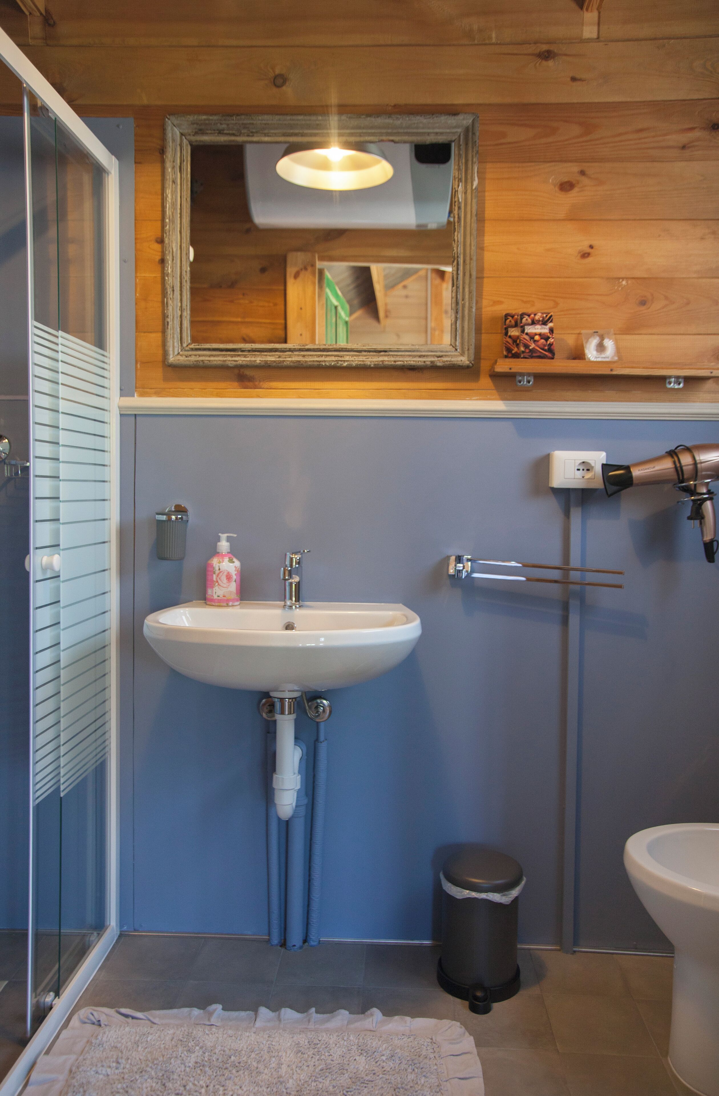 A bathroom with a sink, toilet, and shower.