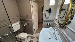 A bathroom with a white toilet, a large sink, a mirror with an ornate frame, and a shower area. - Anapea Village (Kvareli)