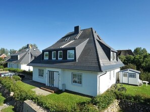 Cozy home with a gabled roof, front entrance, and attached garage.