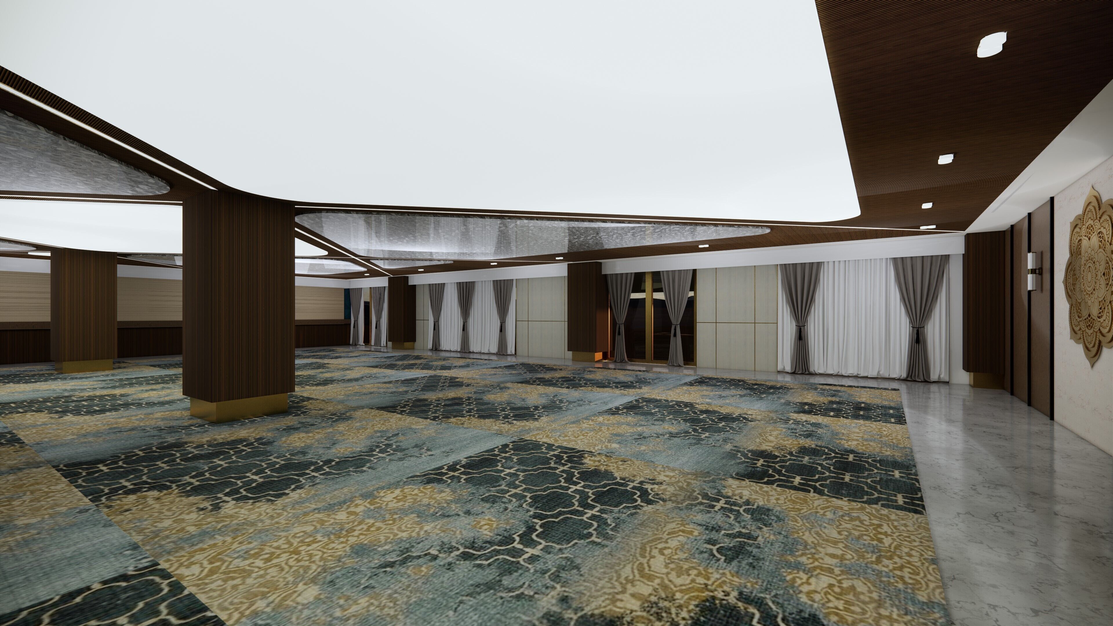 A spacious hall with a patterned carpet, wooden pillars, and a high ceiling with recessed lighting.