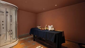 Relax in a serene spa room with a standalone hot tub and comfortable seating area.