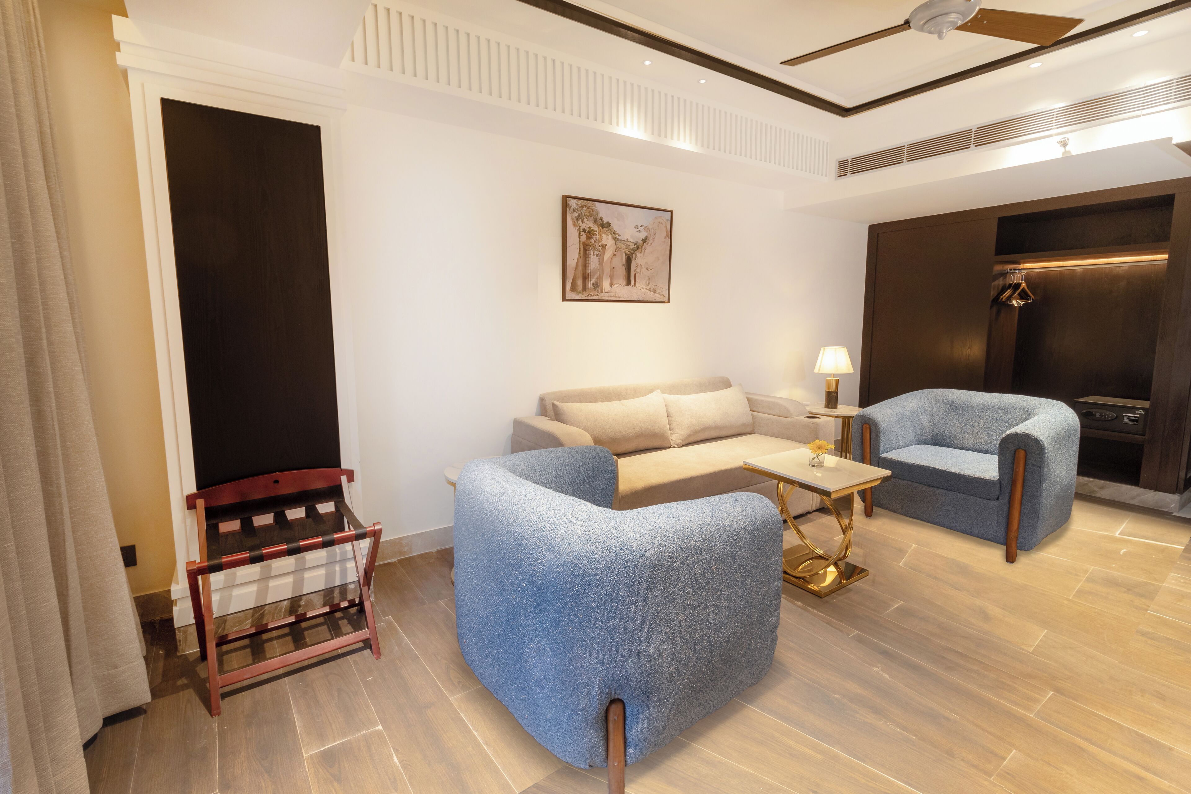 A modern living room with a sofa, armchair, and a small table.
