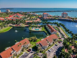 A resort with multiple buildings, a central water feature, and a marina. - 2BR waterfront condo with balcony, pool, hot tub, and beachy views. (St. Petersburg)