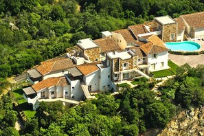 A residential complex with multiple houses, a swimming pool, and surrounding greenery. - Apartment in Golfo Aranci With Terrace (Arzachena)