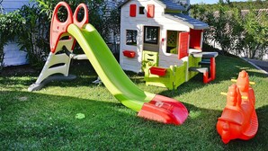 A children's play area with a slide, a small house, and a toy car. - Apartment in Golfo Aranci With Terrace (Arzachena)