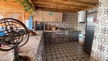 Full-size fridge, oven, stovetop, cookware/dishes/utensils