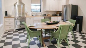 A kitchen with a checkered floor, a stove, a sink, and a refrigerator. - Rest & Relax | Pool | Countryside View | Sleeps 6 (Fayetteville)