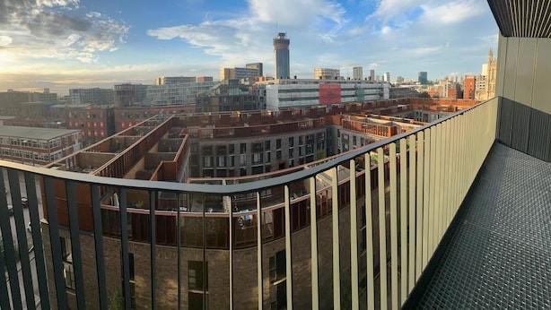 A high-rise building with a view of a cityscape, including a prominent tower and various other buildings. - Apartment - Sleeps 4, Pets Allowed & Free Parking (Manchester)